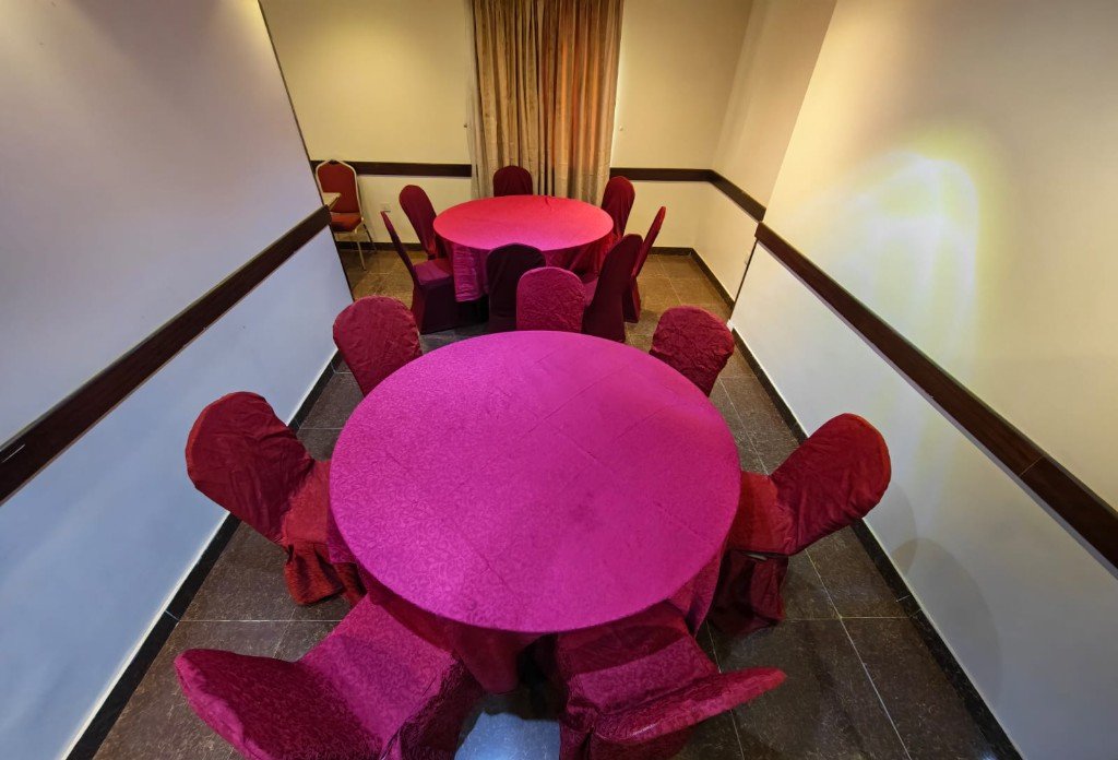 Dining room with round tables and covered chairs