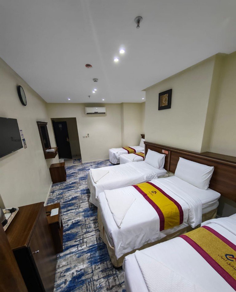 Guest room with a row of single beds